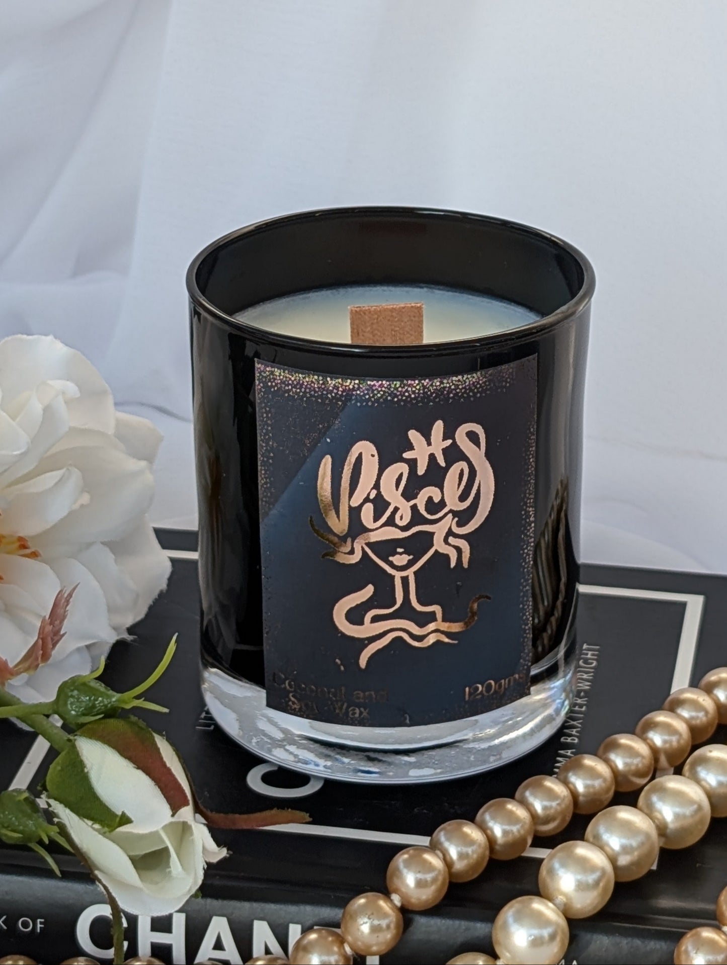 Top view of gold and black Pisces candle by Hazel Glow showing wood wick