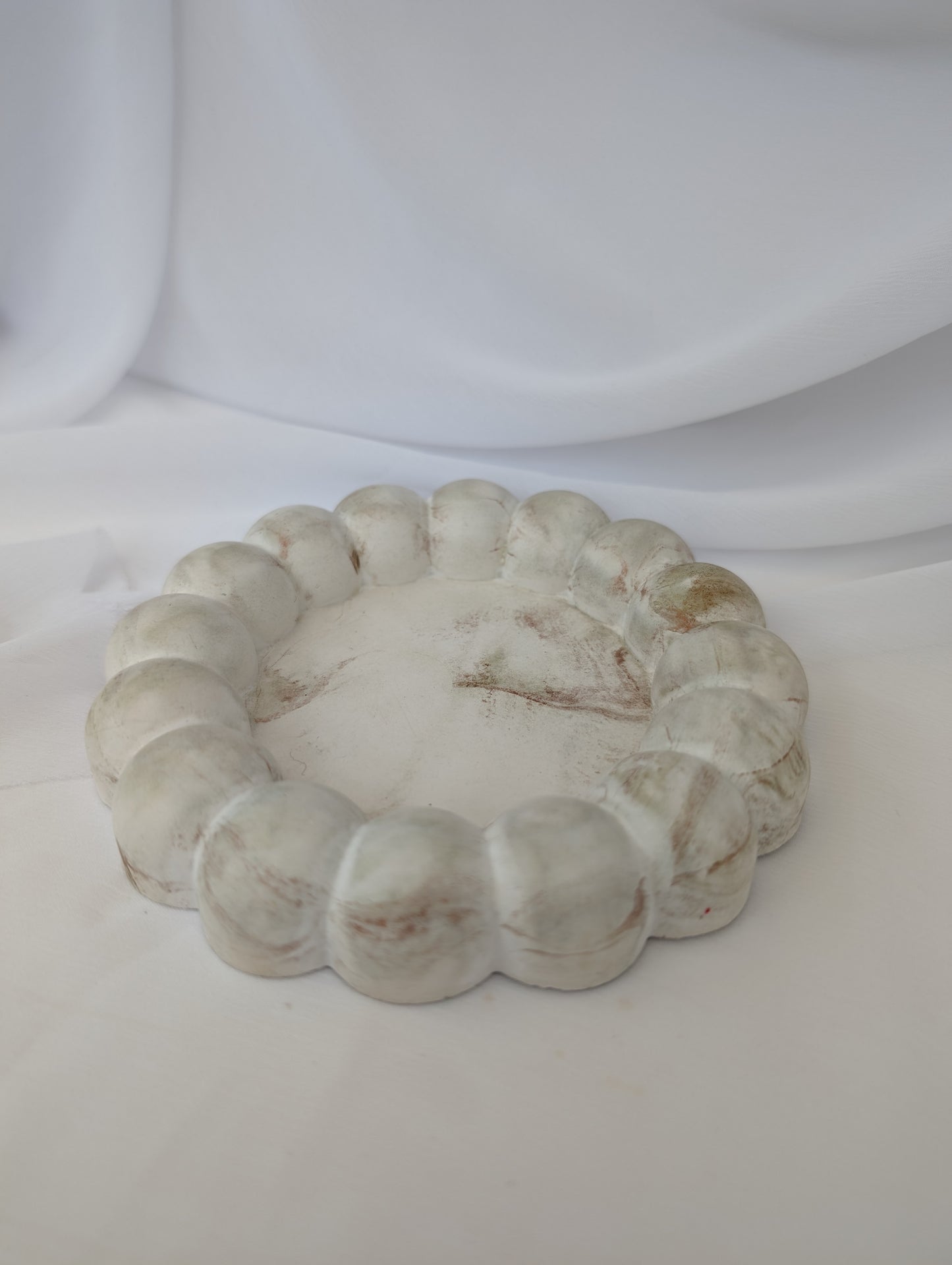 Decorative stone effect bubble trinket tray on a white background
