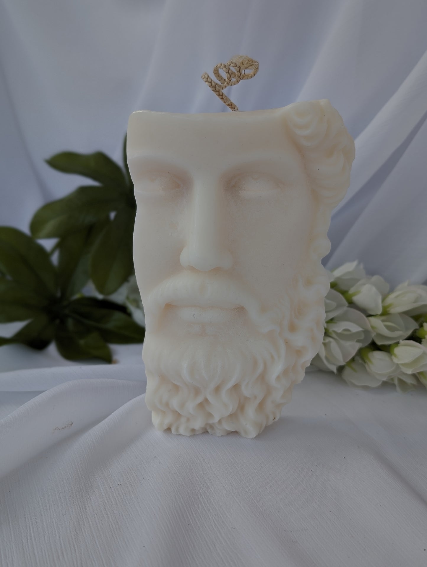 Candle shaped like a classical bust with a white background