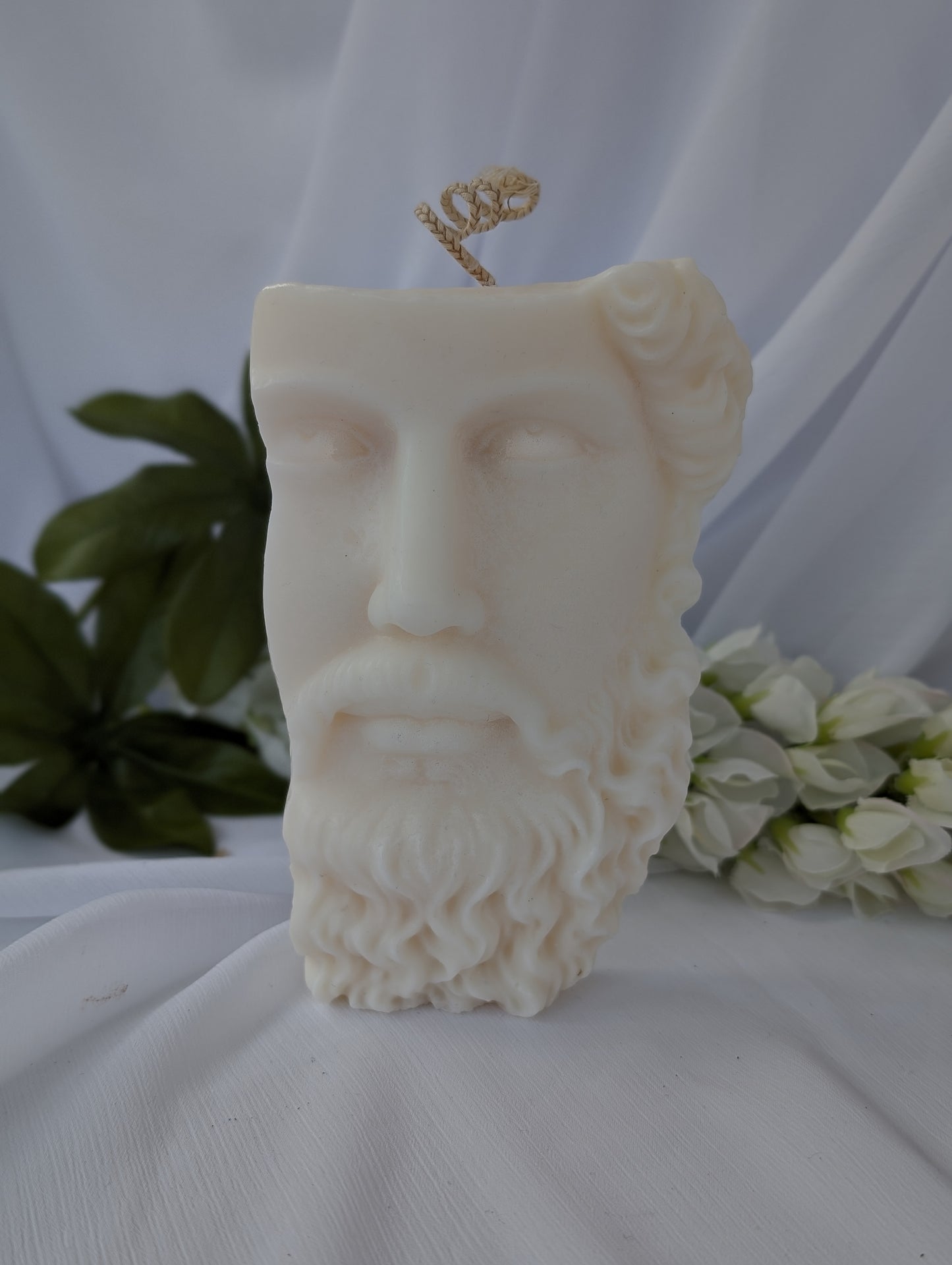 Candle shaped like a classical Greek bust with a white background