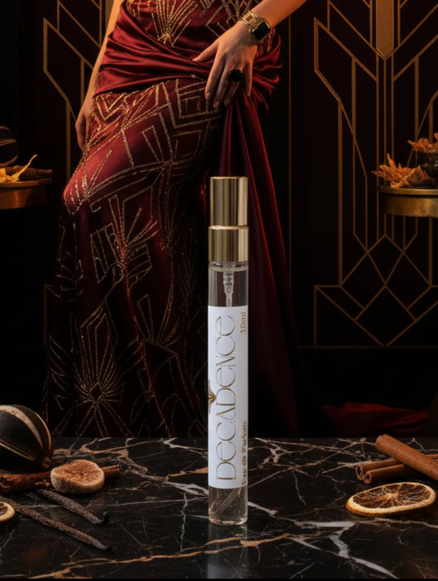 10ml trial size Decadence vegan perfume by Hazel Glow on a black and gold marble surface with art deco background