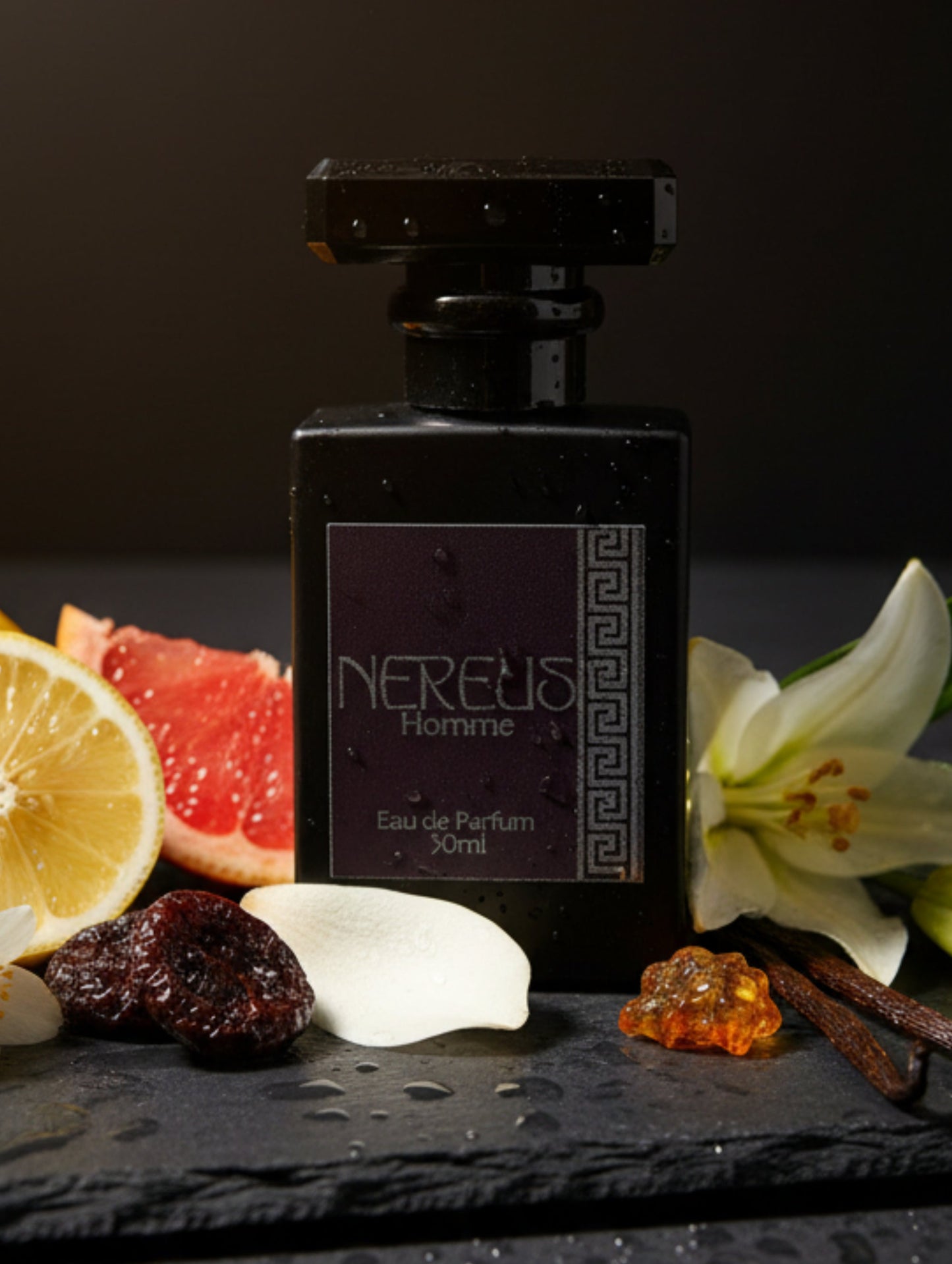 A black rectangular perfume bottle with a dark purple label reading 'NEREUS Homme Eau de Parfum' and a Greek key pattern, shown grey background with lily, grapefruit date, lemon and honey