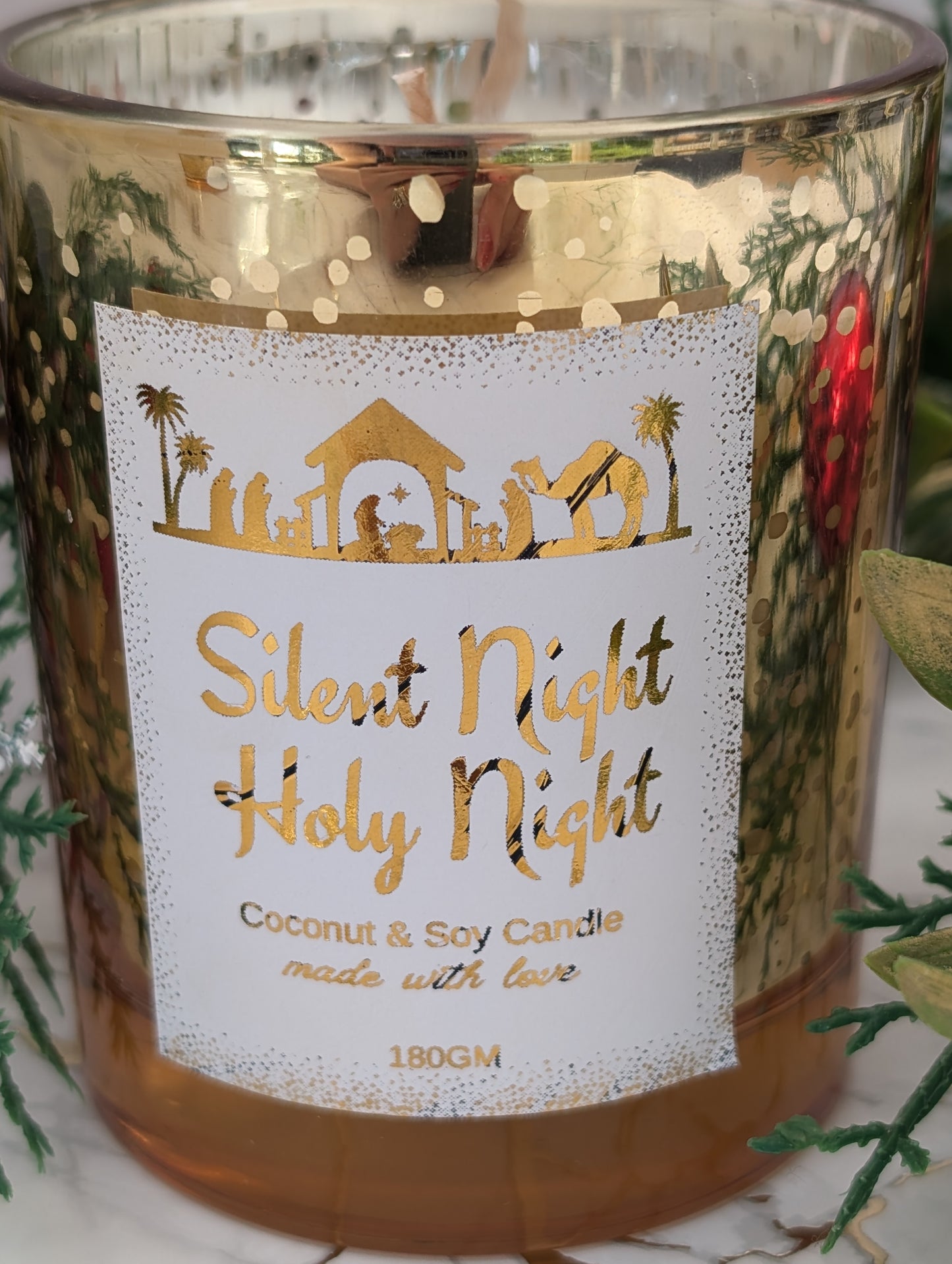 Candle with 'Silent Night Holy Night' label and decorative elements