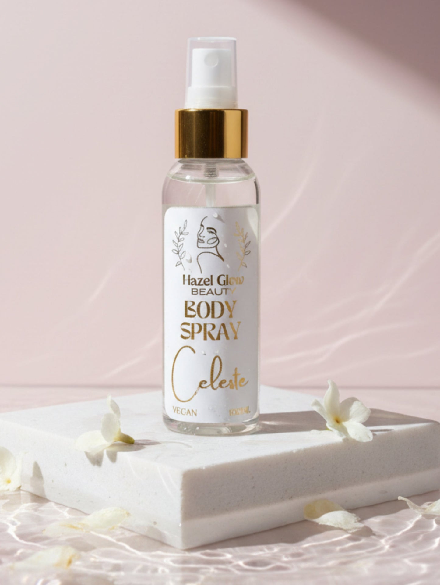 Vegan Body Spray - Celeste by Hazel Glow on a white stone plinth with jasmine petals