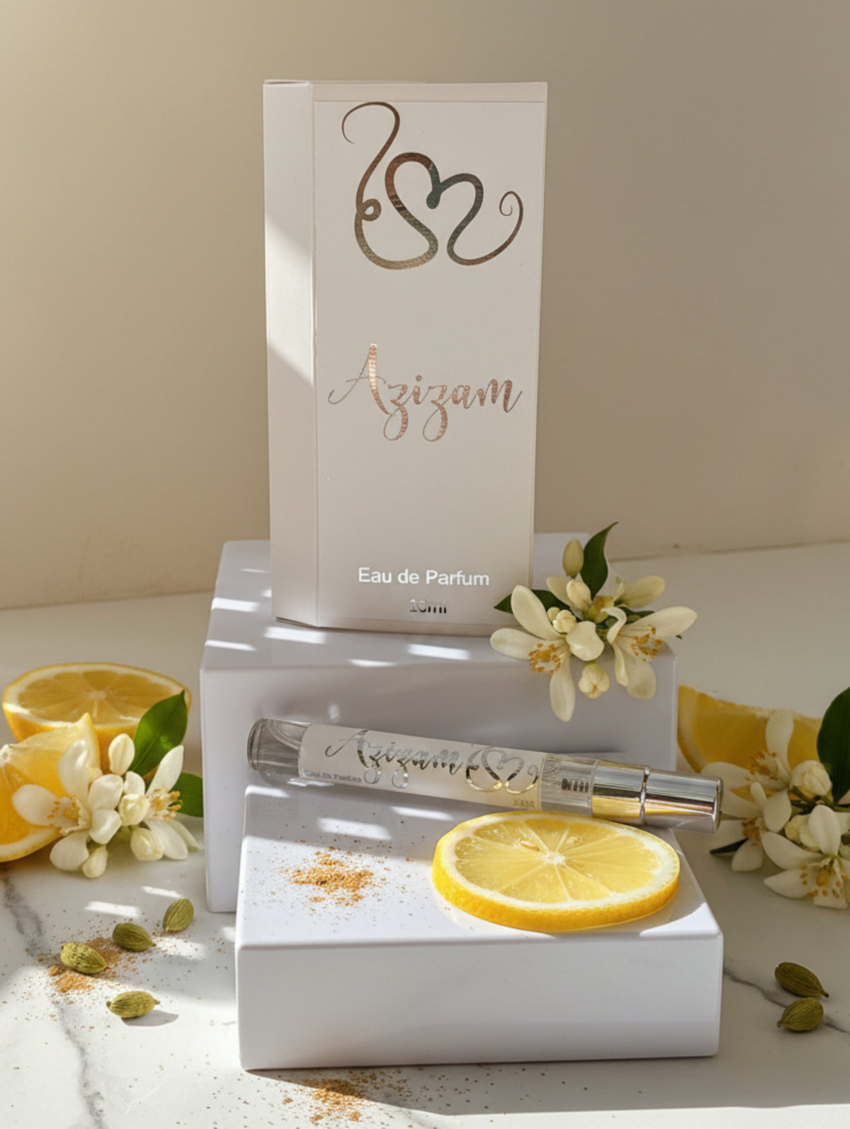 Azizam oud perfume by Hazel Glow.  Arabian perfume for women 10ml discovery size on white plinths with jasmine, lemon and cardomom