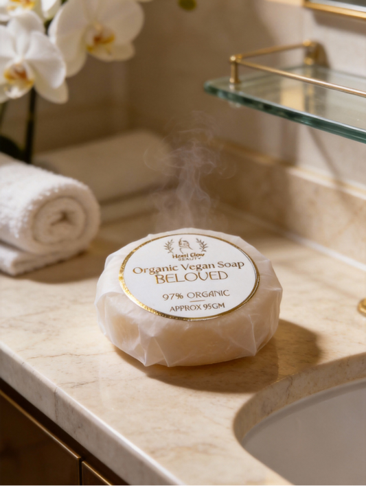 Bar of soap on a bathroom counter with flowers and a mirror in the background