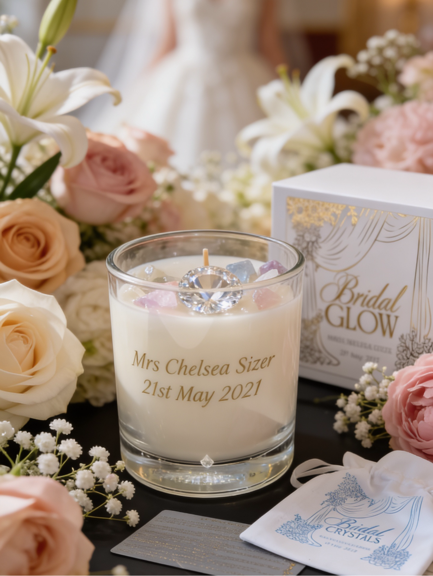 Personalised candle with floral arrangement and blurred bride in the background