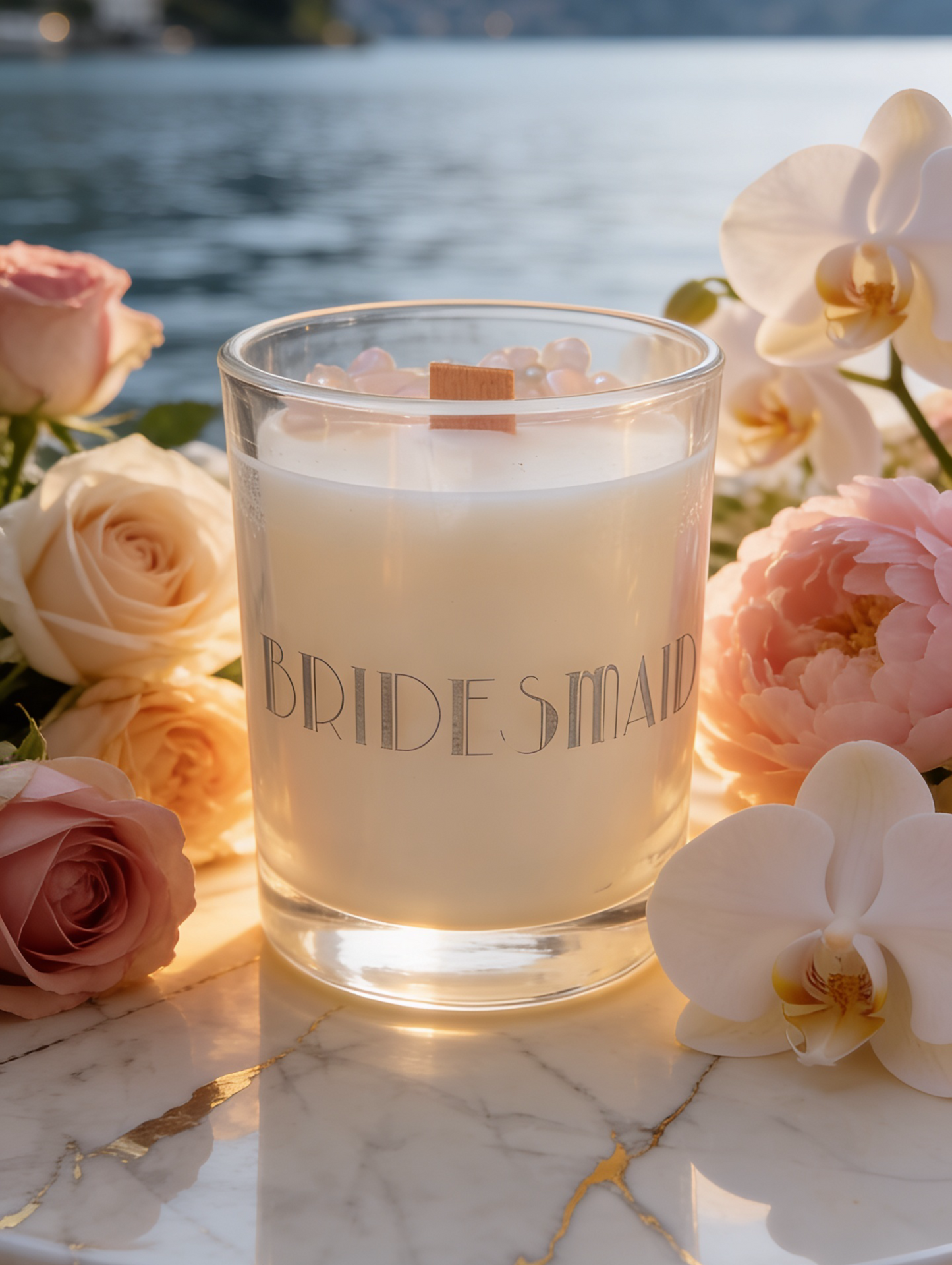 Bridesmaid Gift - Crystal candle, personalised gift with  Bridesmaid etched in Art deco style letters and silver finish.  On a marble table with flowers in front of a lake