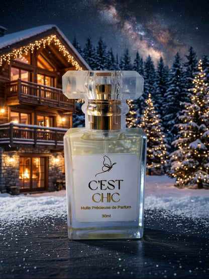 C'est Chic luxury perfumed spray oil by Hazel Glow.  Vegan, Cruelty Free and Paraben Free.  Glass bottle with faceted lid shown against a winter alpine setting