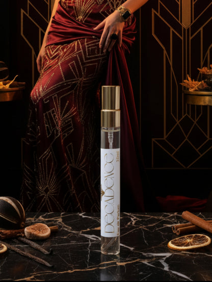 10ml trial size Decadence vegan perfume by Hazel Glow on a black and gold marble surface with art deco background

