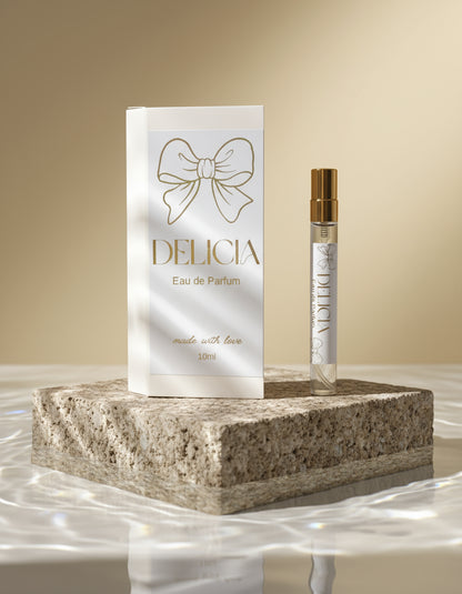 Delicia Eau de Parfum bottle and packaging with decorative elements on a surface.