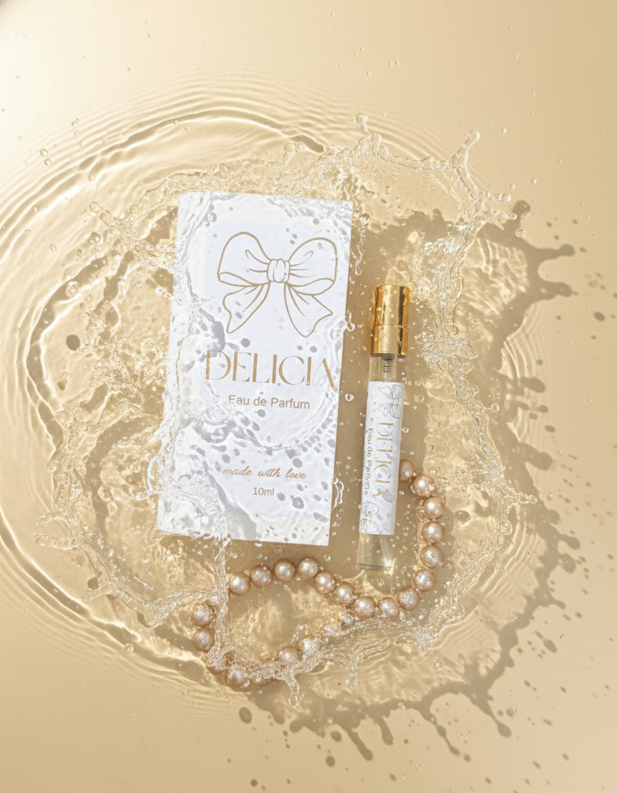 Delicia Eau de Parfum bottle and packaging with a bow design on a blurred background