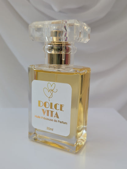 Dolce Vita Perfume Spray oil against a white draped background - by Hazel Glow