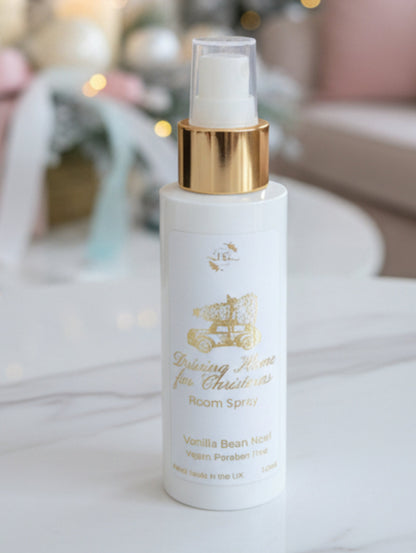 Christmas Room Spray by Hazel Glow.  Driving Home for Christmas in Vanilla Bean Noel fragrance in a white bottle with gold collar and gold foiled Christmas label