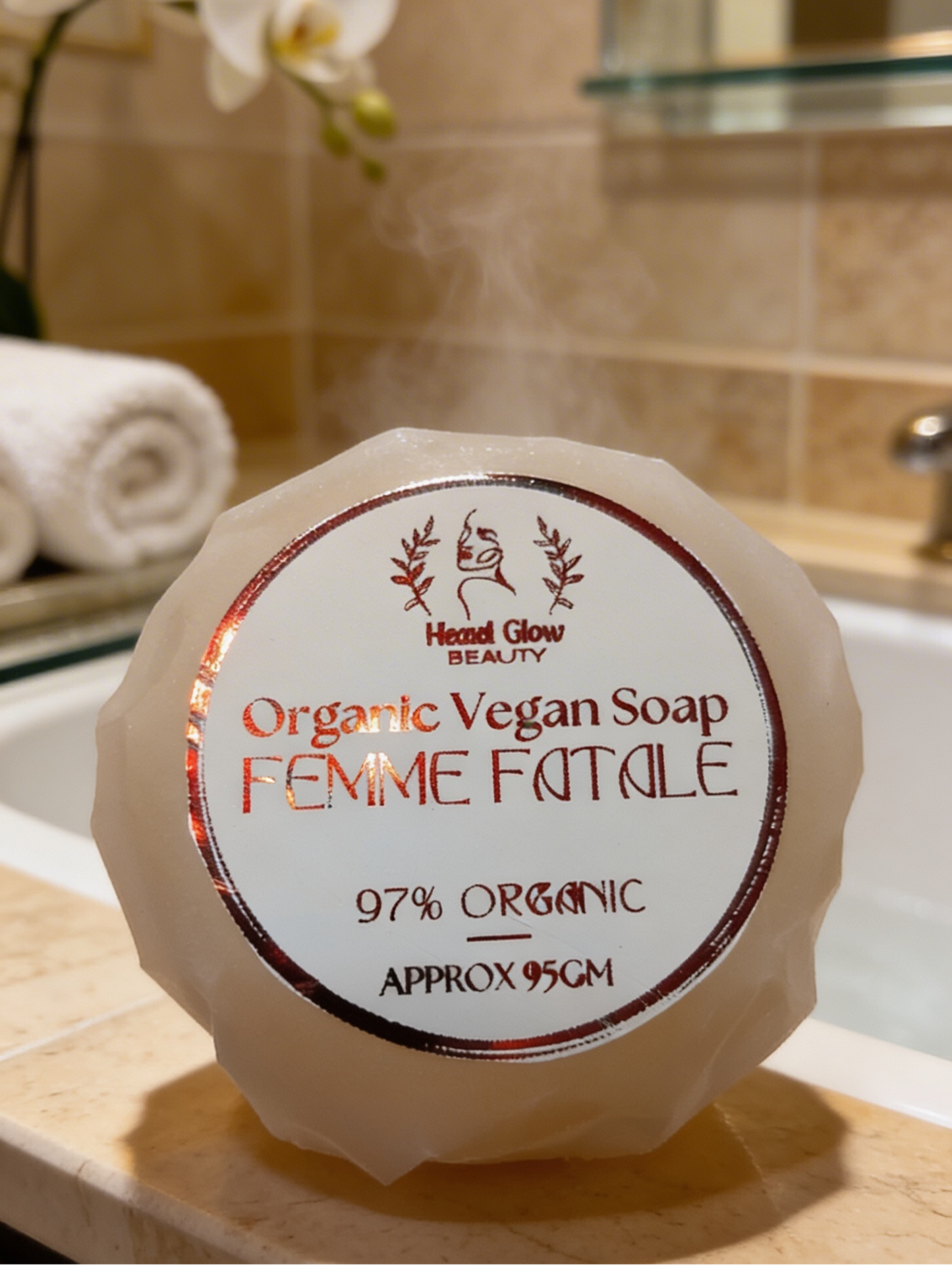 Organic Vegan Soap labeled 'Femme Fatale' on a bathroom counter with a blurred background.