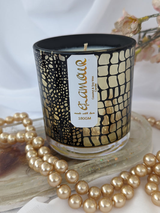 Luxury Candle in gold and black crocodile pattern container, with gold foiled Glamour label and pearls in the foreground