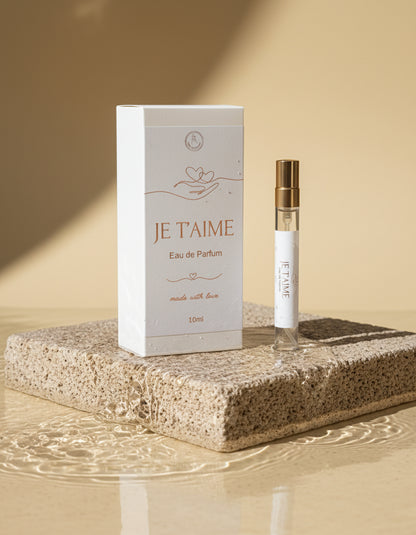 JE T'AIME eau de parfum packaging with a small perfume bottle on a stone surface in water