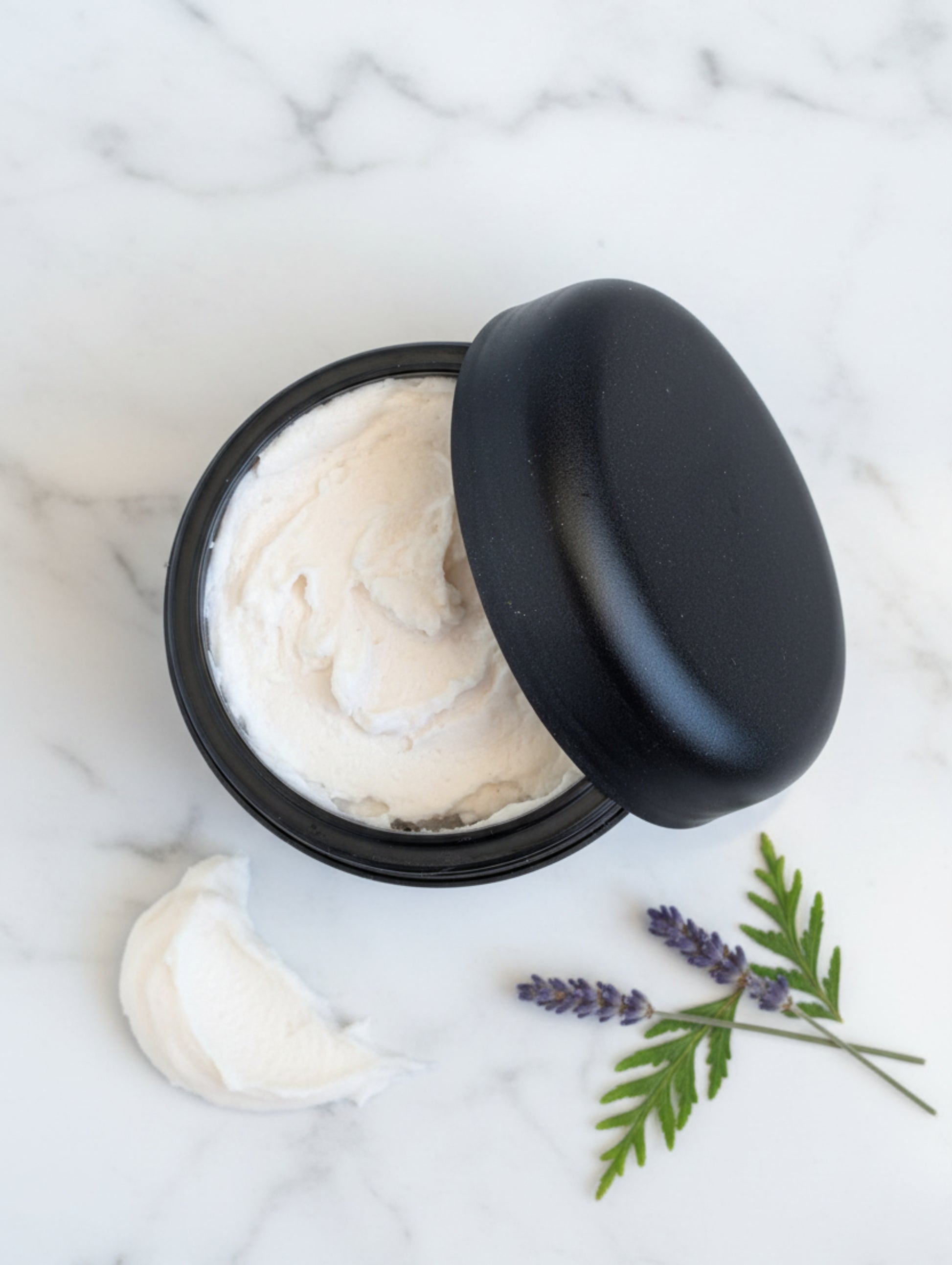 Kyanos luxury shave butter by Hazel Glow.  Open jar showing texture of cream

