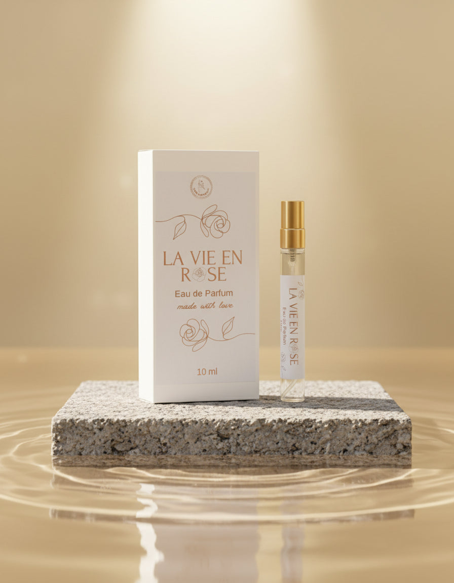 La Vie en Rose vegan perfume 10ml bottle and packaging on a rock plinth in water