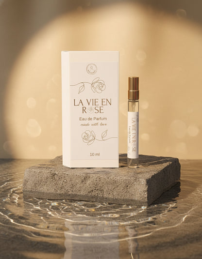 La Vie En Rose perfume packaging with a small bottle on a decorative surface.