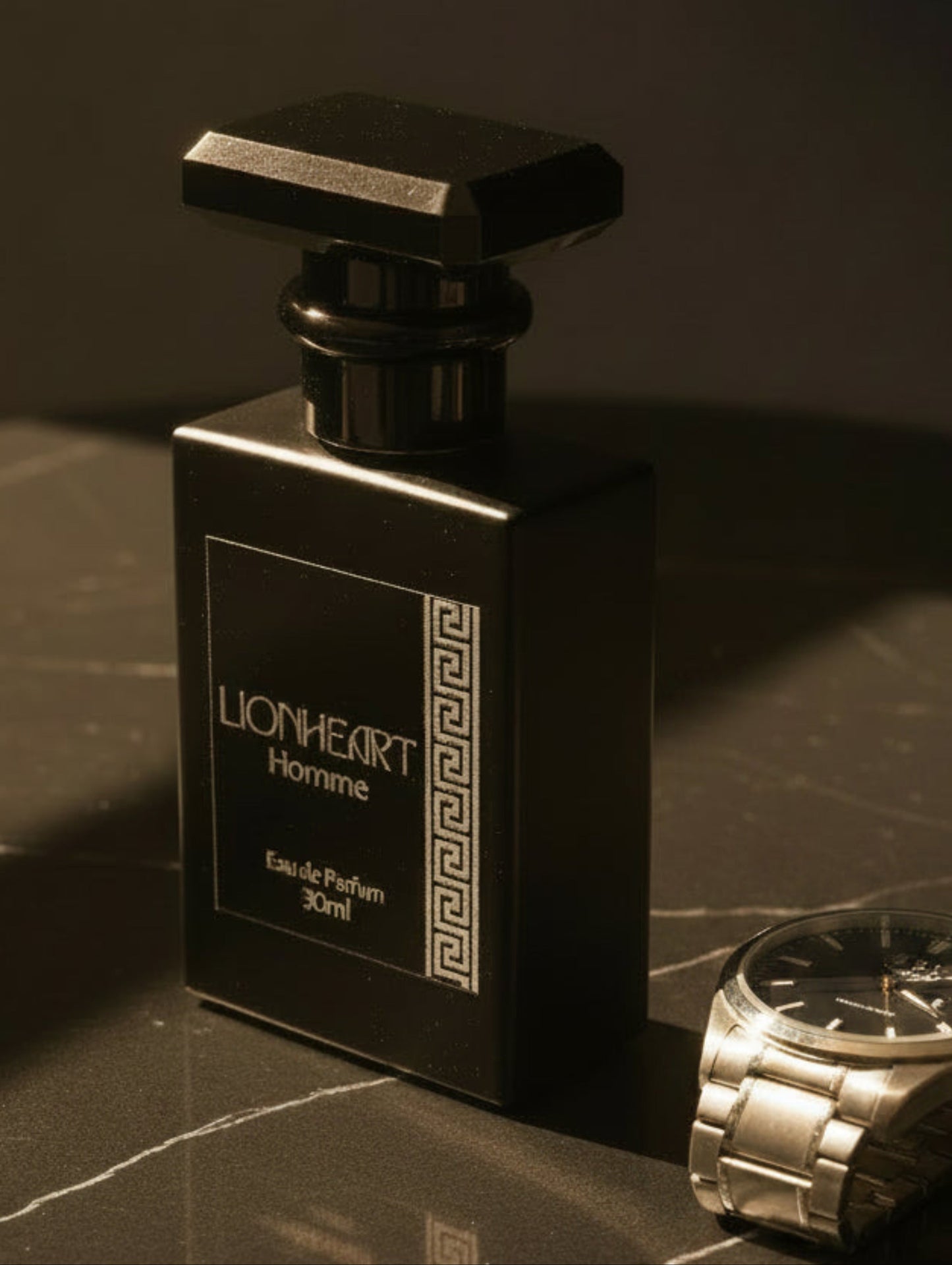 A 30ml bottle of Lionheart Homme Eau de Parfum, featuring a matte black rectangular bottle with a faceted black cap and a dark label with silver foil text and a Greek key pattern.