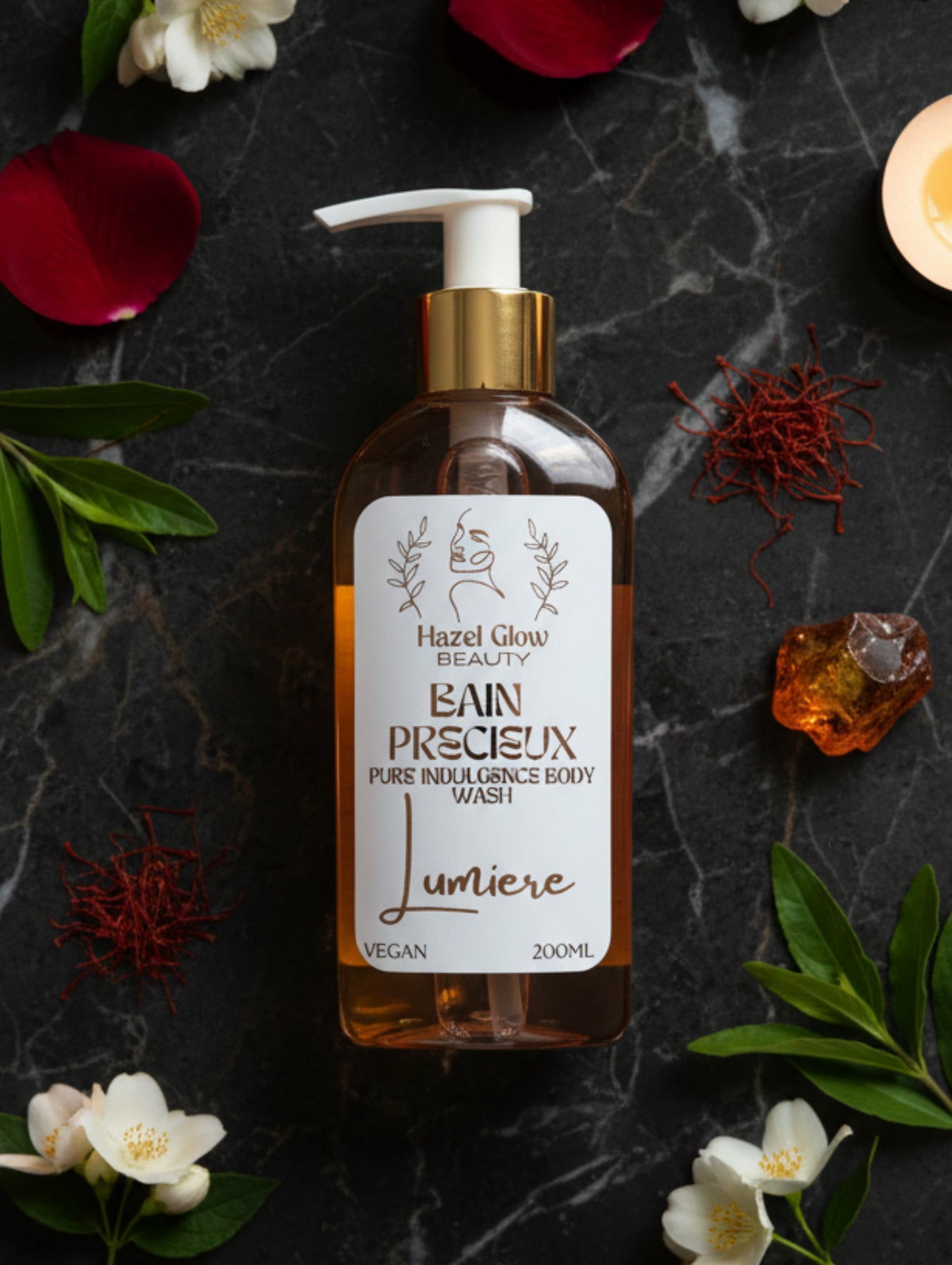 Lumière Body Wash "Bain Precieux" by Hazel Glow.  Shower gel with organic ingredients 200m pump bottle with gold cap surrounded by petals and amber