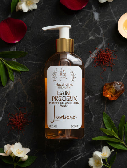 Lumière Body Wash "Bain Precieux" by Hazel Glow.  Shower gel with organic ingredients 200m pump bottle with gold cap surrounded by petals and amber