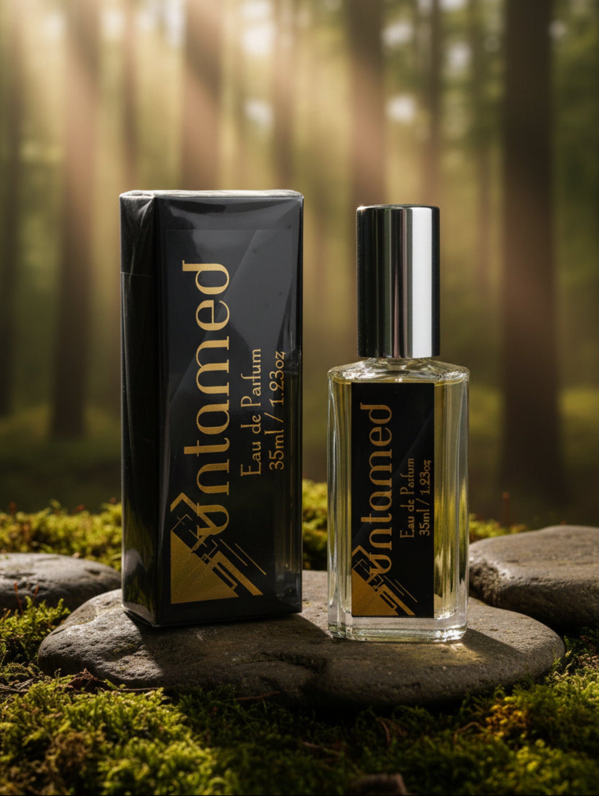Men's Eau de Parfum - untamed by Hazel Glow.  Black and gold packaging on stone in a forest