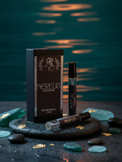 Men's Fragrance Nereus - Oriental Travel Size Perfume for Men by Hazel Glow.  Men's Eau de Parfum 10ml bottle with black label and silver detailing with box surrounded by sea glass and sea in the background