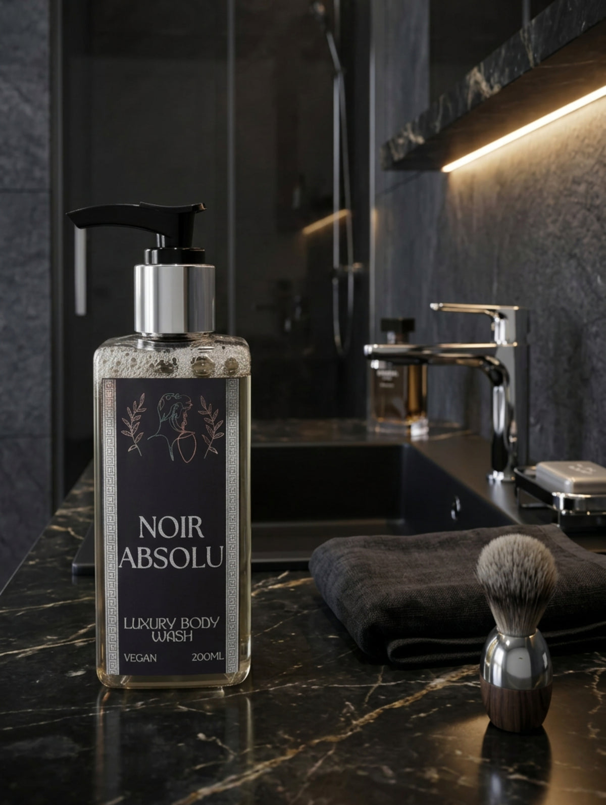 A bottle of Noir Absolu Luxury Body Wash with a black pump dispenser and a dark label with silver foil, in a dark marble blackground