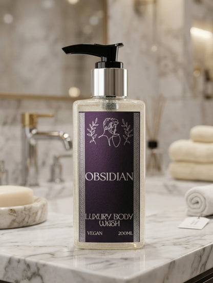 OBSIDIAN Luxury Body Wash in a clear rectangular bottle with a black pump dispenser and a black and silver foil label shown in a luxury marble bathroom