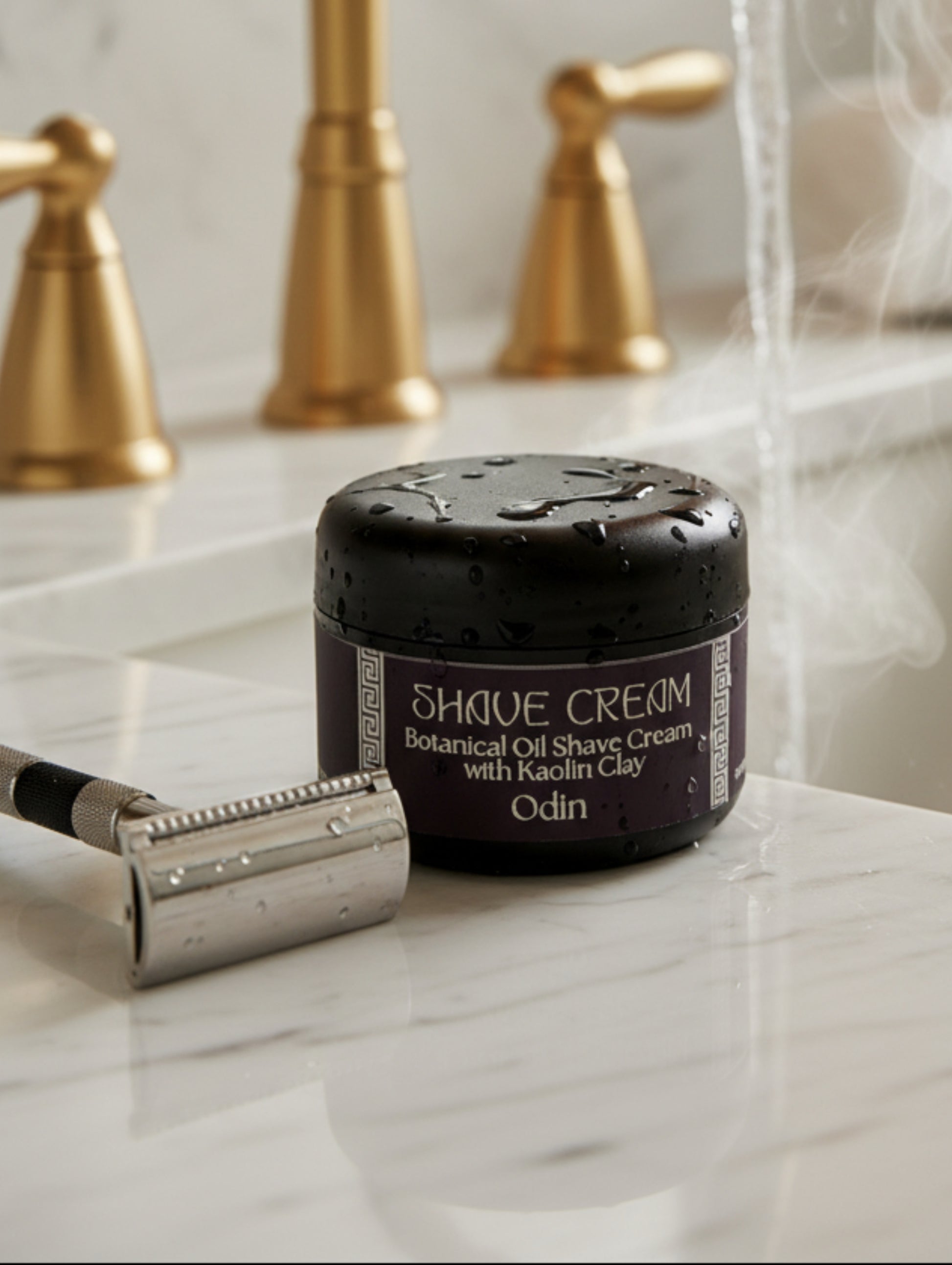 Vegan Shave Cream For Men on a marble worktop by a sink with gold taps
