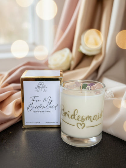 Candle with 'Bridesmaid' text and gift box on a dark surface
