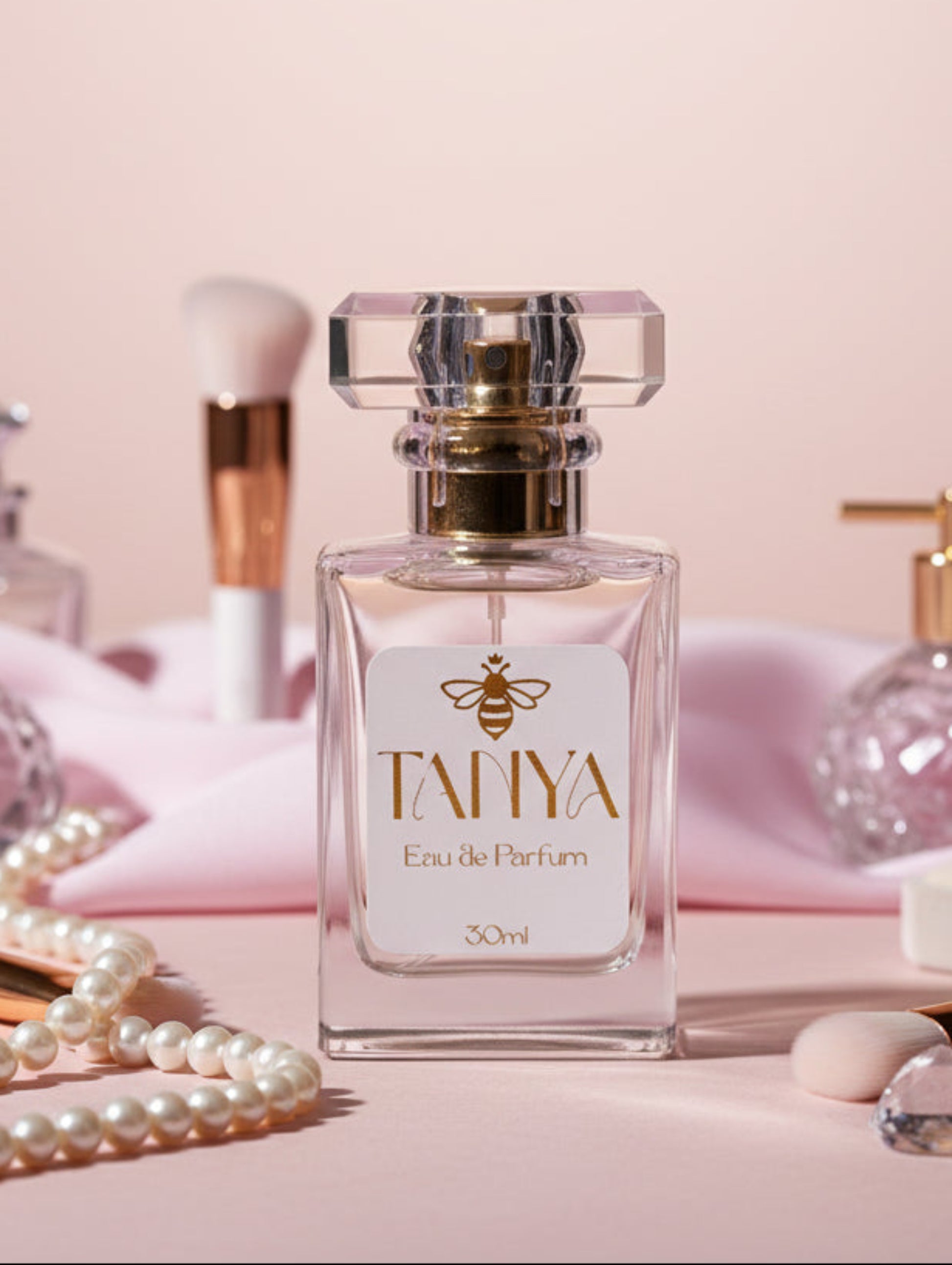 Personalised Perfume bottle labeled 'Tanya' with jewellery and makeup items on a pink background