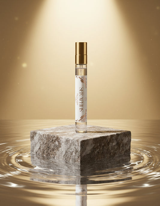 Seraphine vegan Perfume bottle with gold cap on a rock in water 