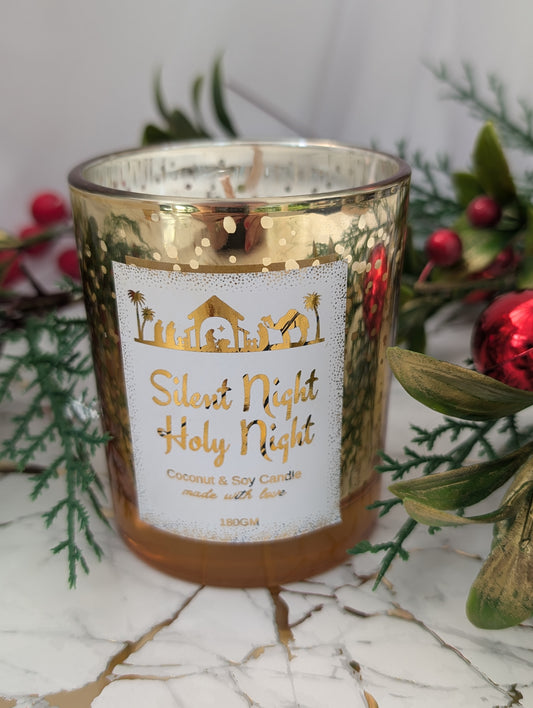 Gold Christmas Candle with 'Silent Night Holy Night' label surrounded by greenery and red berries