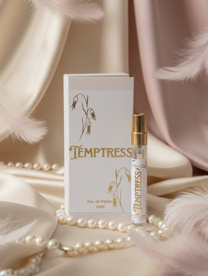 Vegan seductive Temptress eau de parfum 10ml perfume against satin background with pearls and feathers
