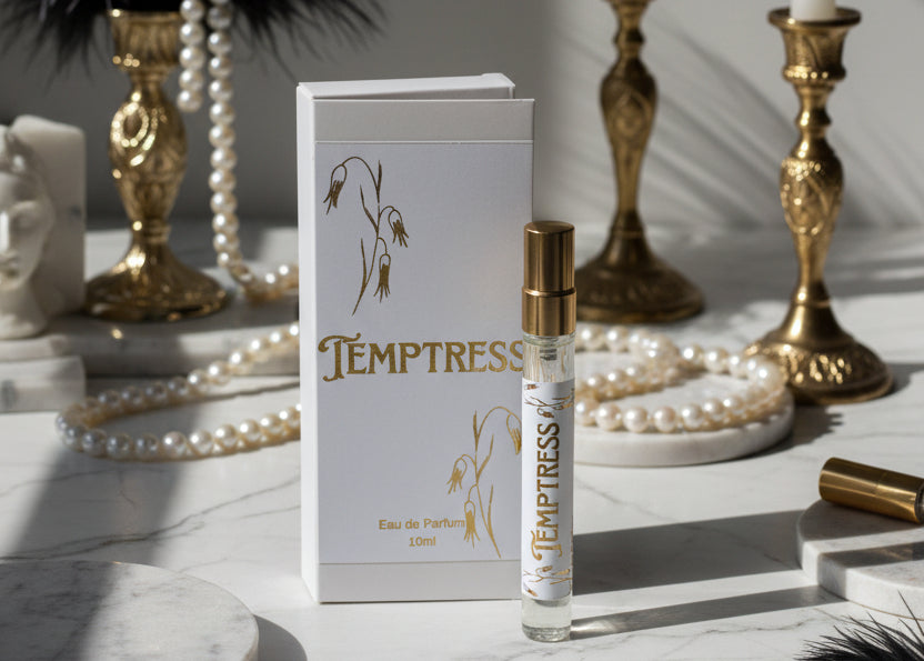 Temptress eau de parfum bottle and packaging on a marble surface