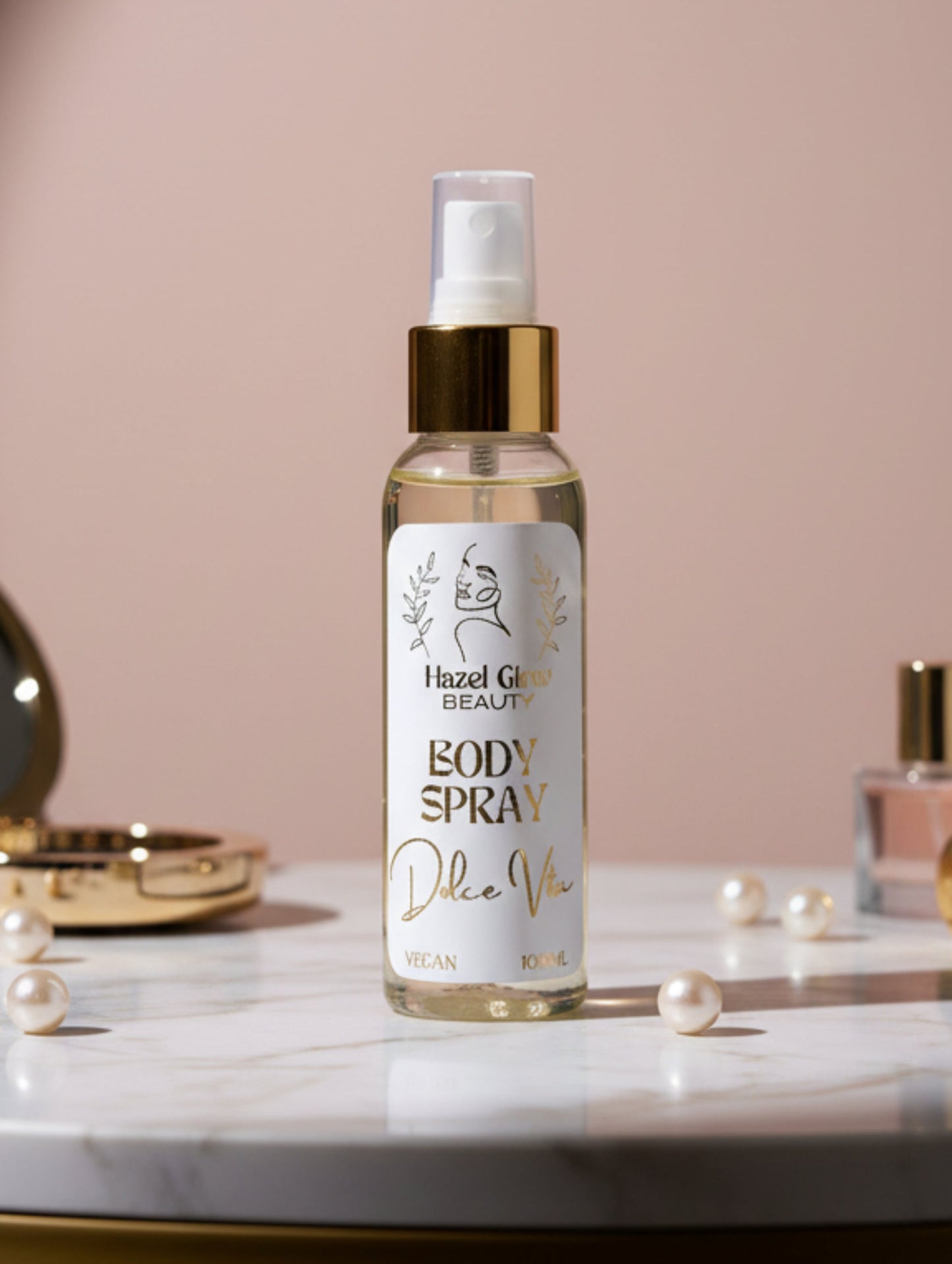 Body spray bottle with 'Hazel Glow Beauty' label on a plain background