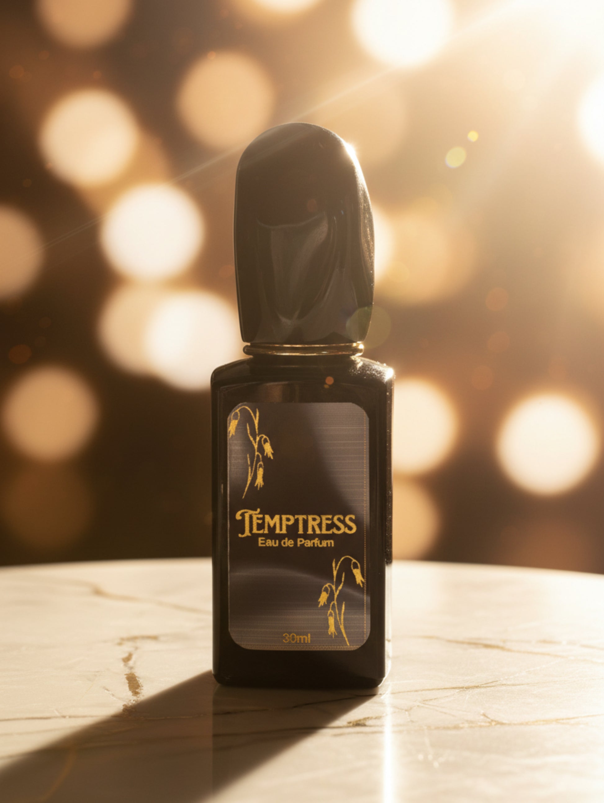 Black Temptress vegan perfume 30ml on a marble surface with a bokeh background