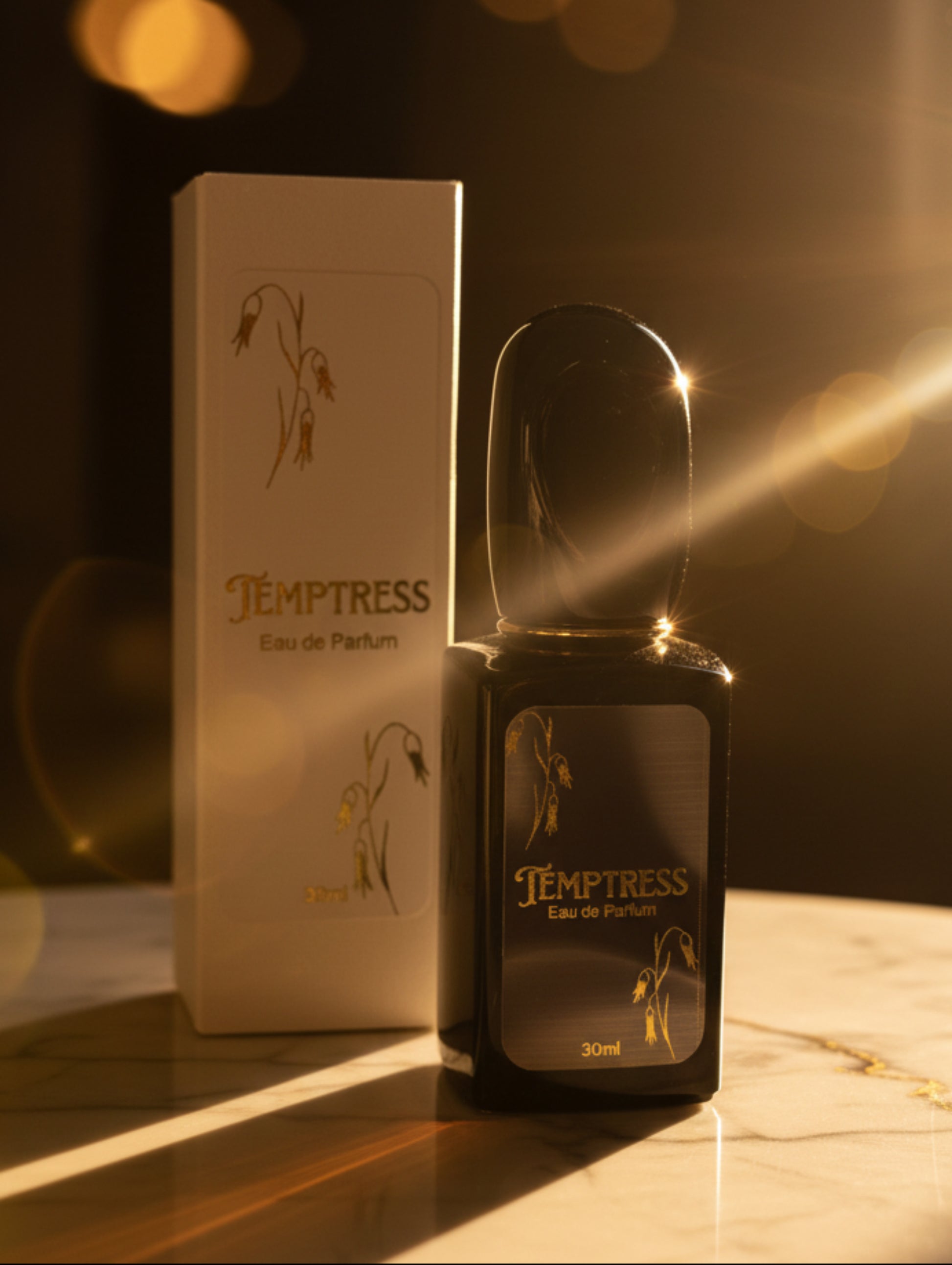 Temptress Eau de Parfum bottle and packaging on a marble surface