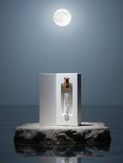 Vegan Perfume Celeste by Hazel Glow 10ml trial size on a stone plinth in water with moonlight reflecting