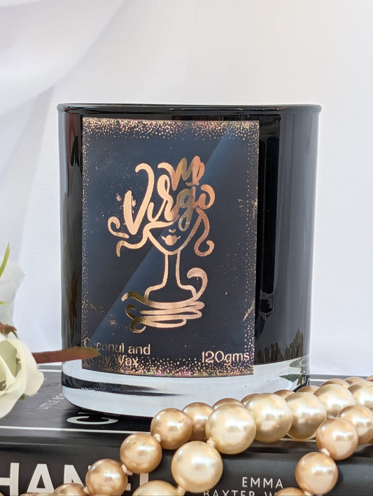 Virgo star sign candle - black and gold on a black book with pearls