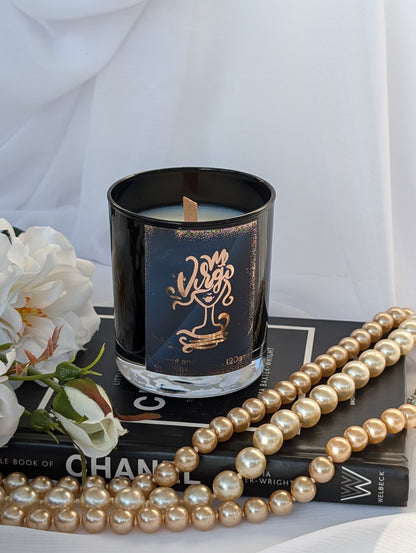 Virgo black and gold star sign candle on black book with pearls and white flower