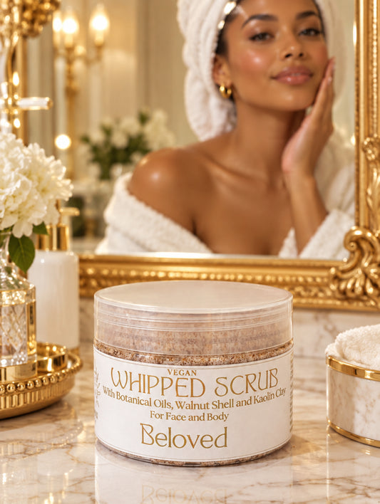 A jar of Beloved Vegan Whipped Scrub with botanical oils, walnut shell, and kaolin clay, shown on a neutral light beige background.