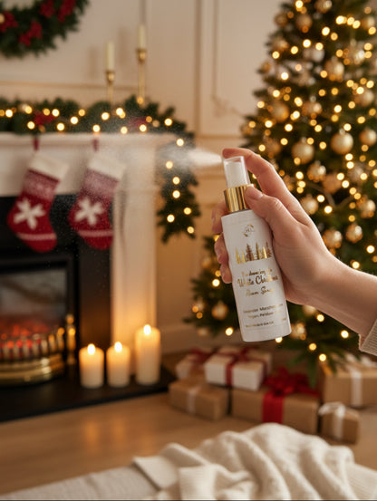 White Christmas Festive Fragrance Room Spray by Hazel Glow.  In a white and gold bottle with gold foiled label.