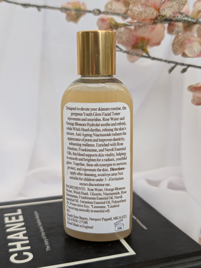 Ingredients label of Youth Glow Facial toner bottle with gold cap and white label on a Chanel magazine background