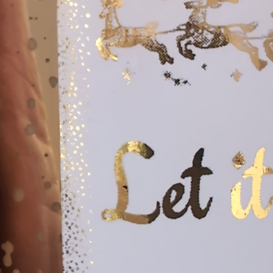 Close up detail of gold foiled label on Let it Snow Candle by Hazel Glow