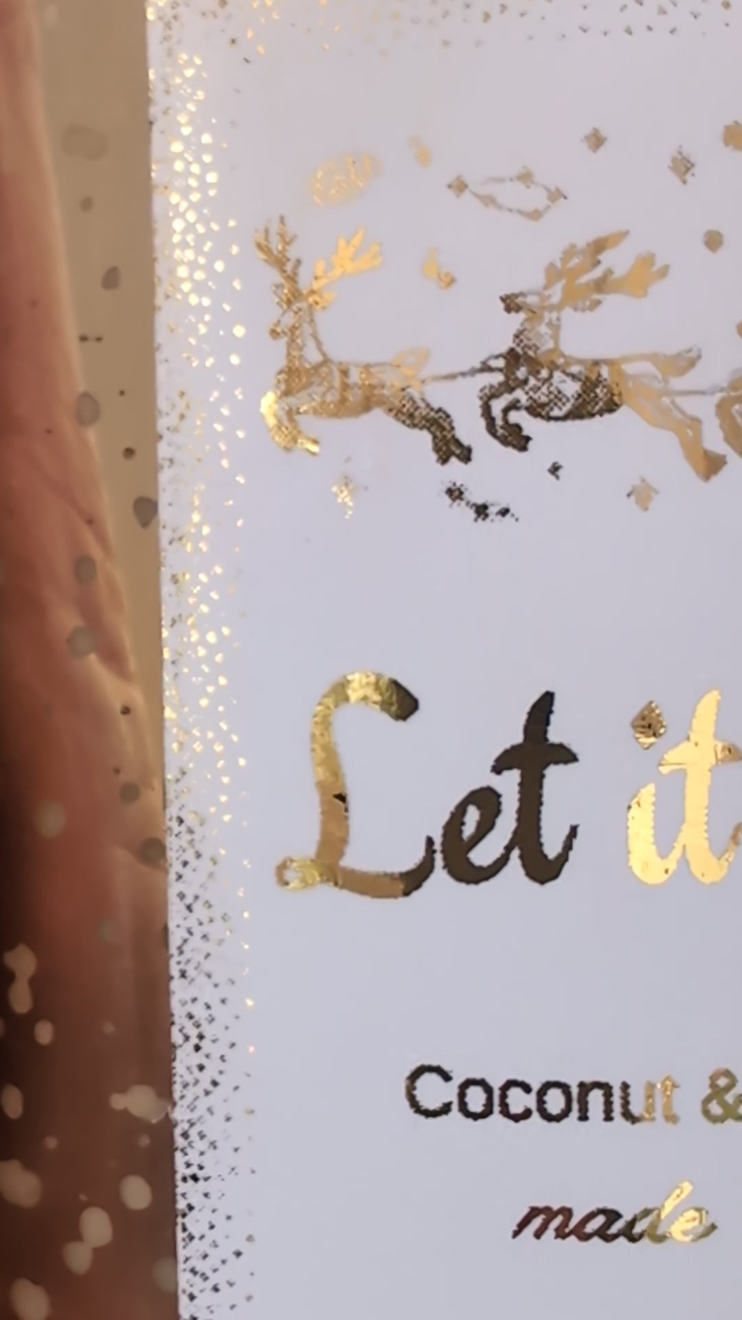 Close up detail of gold foiled label on Let it Snow Candle by Hazel Glow