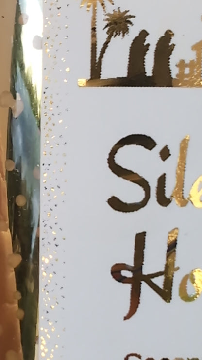 Close up of gold foil details on the Silent Night Gold Christmas Candle label